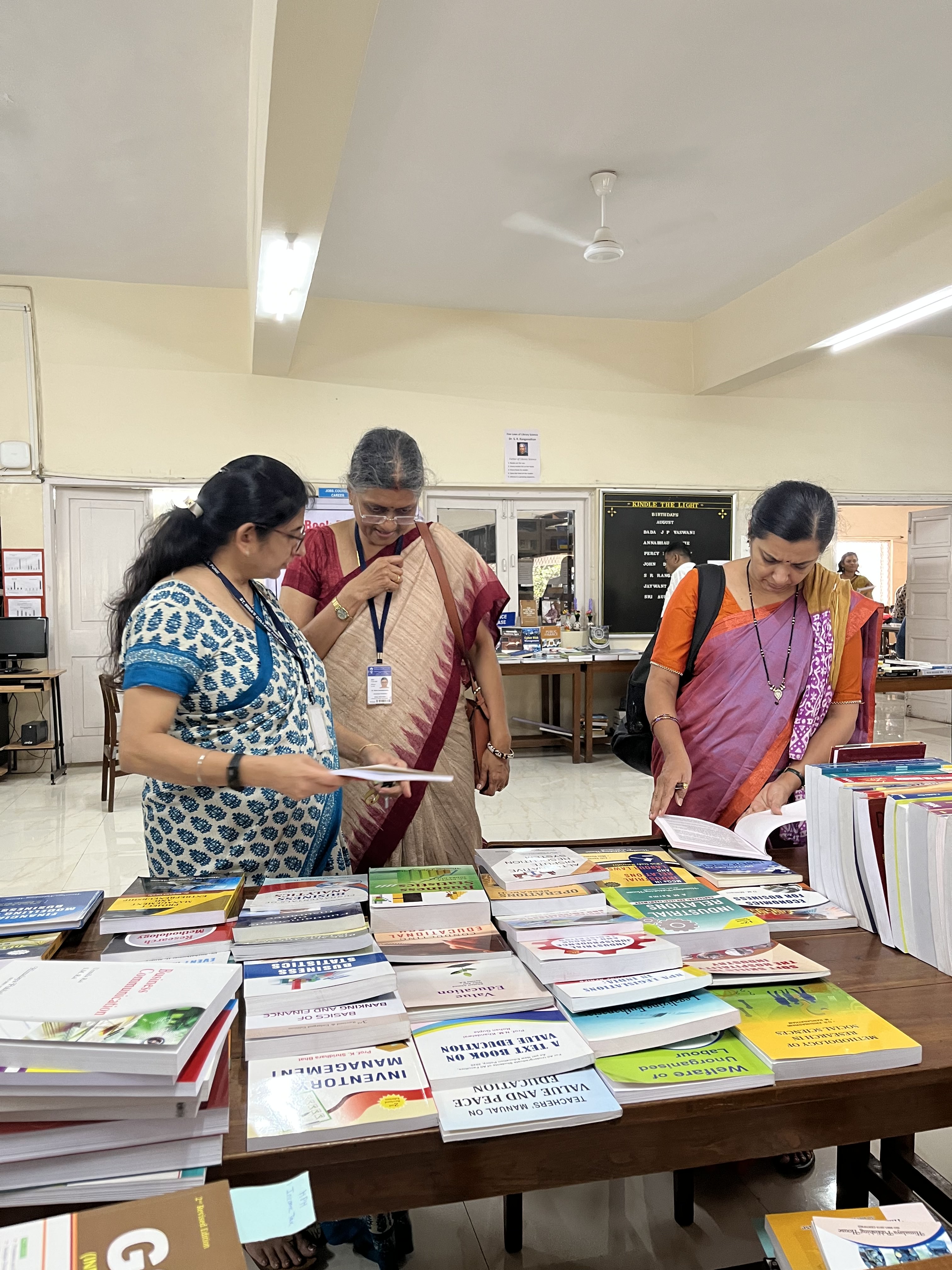 3Teachers perusing the books at the Exhibition 